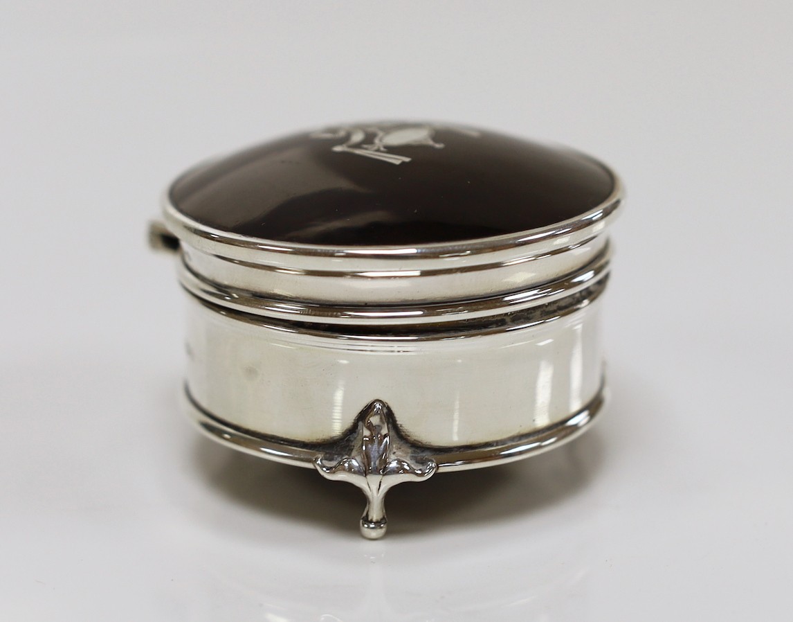 A George V silver and tortoiseshell pique mounted circular trinket box, Robert Pringle & Sons, London, 1922, 62mm.